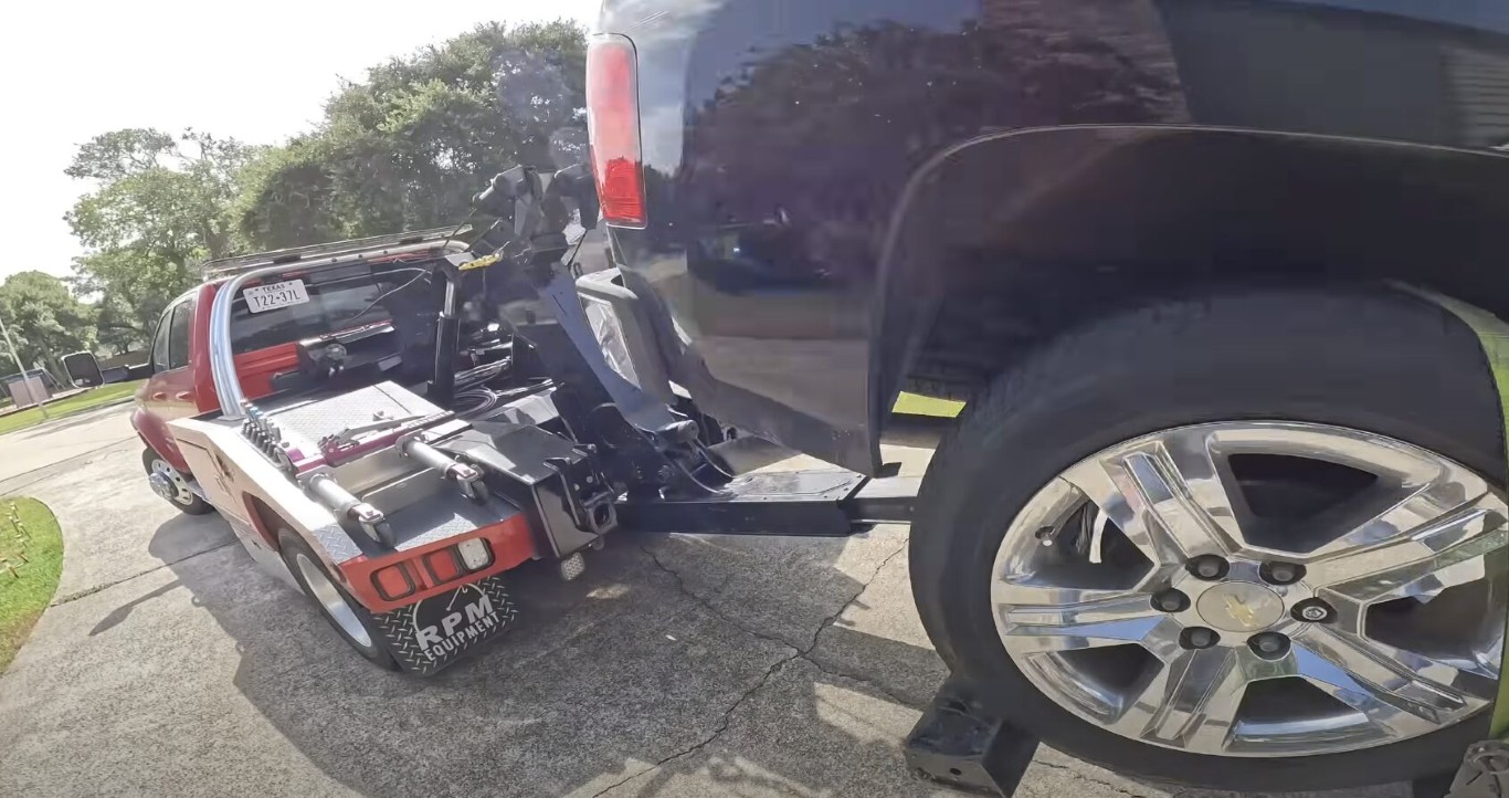 Tow truck operator assisting with a car lockout service in West Babylon, NY